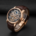 Luxury watch with rose gold case on dark slate surface